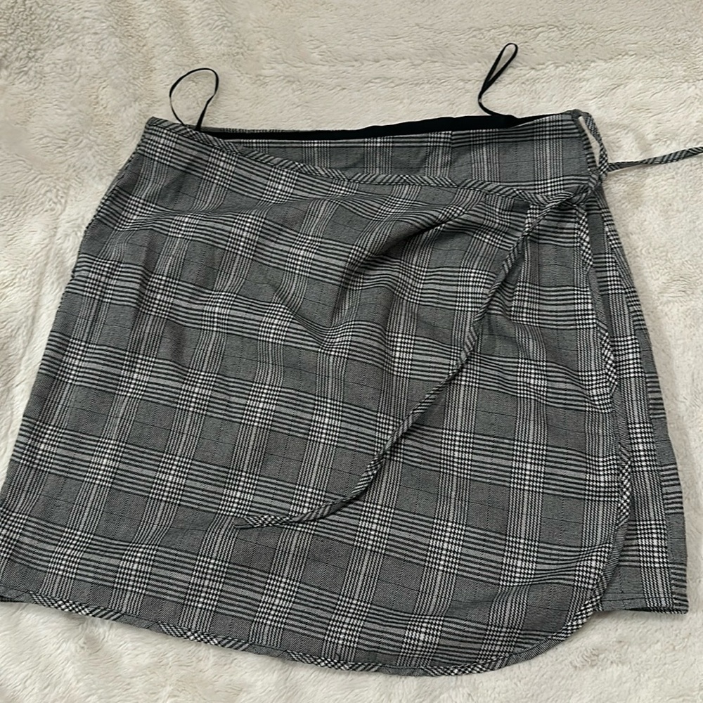 It’s a tie up mini skirt with a button and an extra button for length if needed